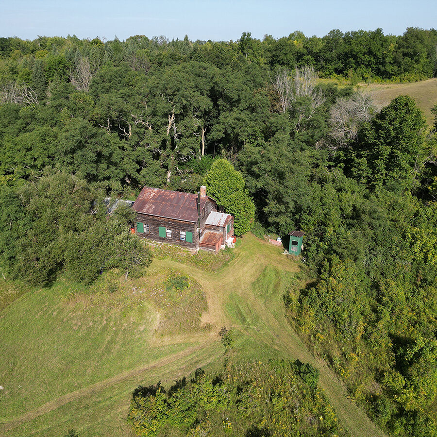 Drone view of farmhouse and trees