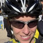 woman wearing biking helmet and sunglasses