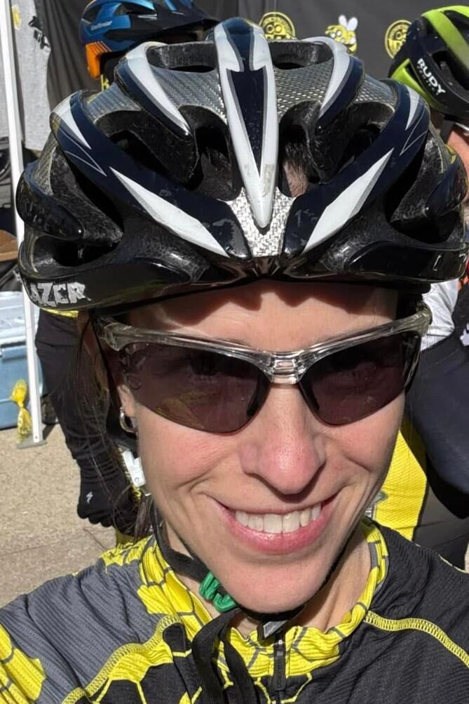 woman wearing biking helmet and sunglasses