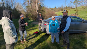 group of birders by a car