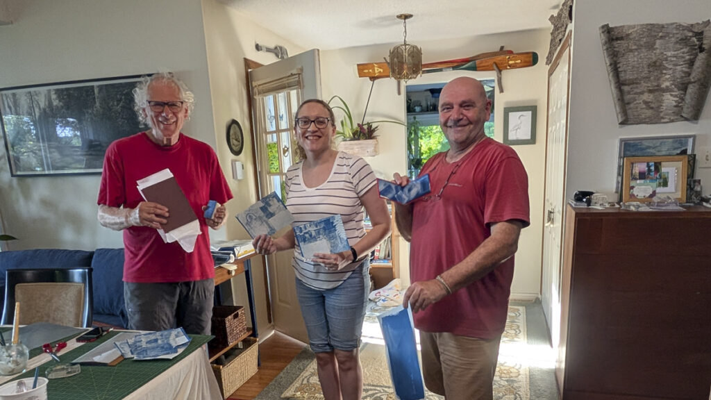 3 people holding book projects