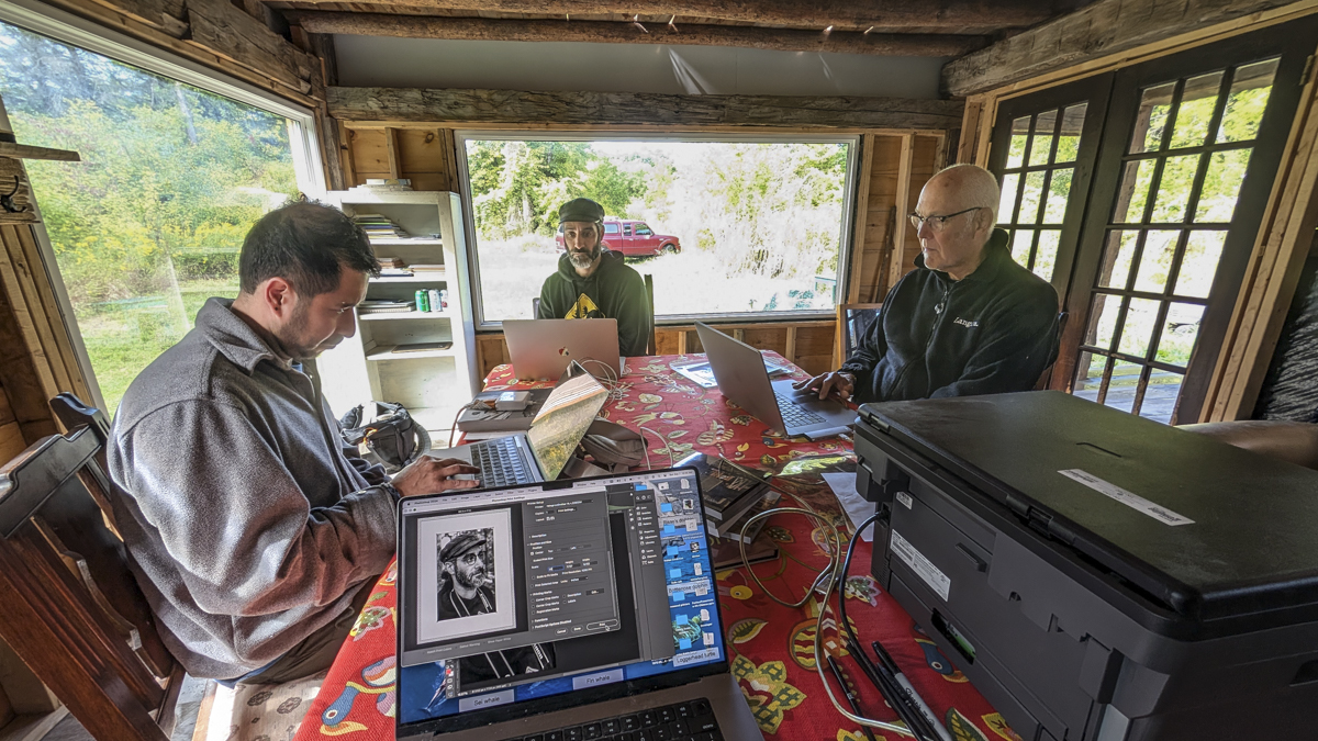 group sitting at a table with laptop computers