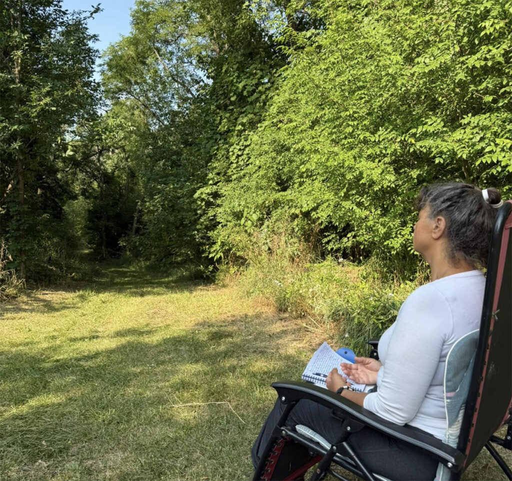 woman sitting in chair looking at the landscape